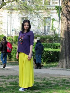 Young woman wearing purple and yellow outfit