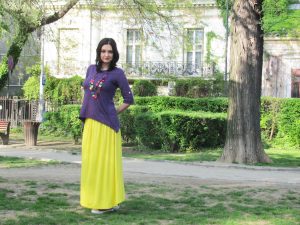 Brunette woman wearing purple and yellow